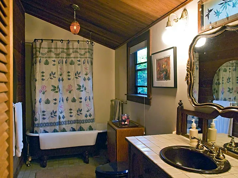 Bathroom with clawfoot tub & shower.
