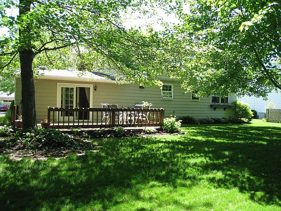 Back yard has deck, shade trees