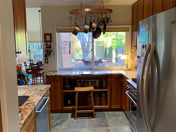 Kitchen with hanging pot holder, large refrigerator