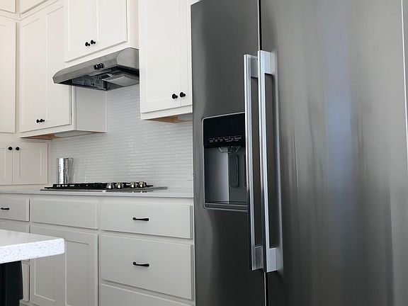 Stainless refrigerator with crushed ice feature, and filtered water dispenser. It even has a programable measured water dispenser. This kitchen has amazing storage.