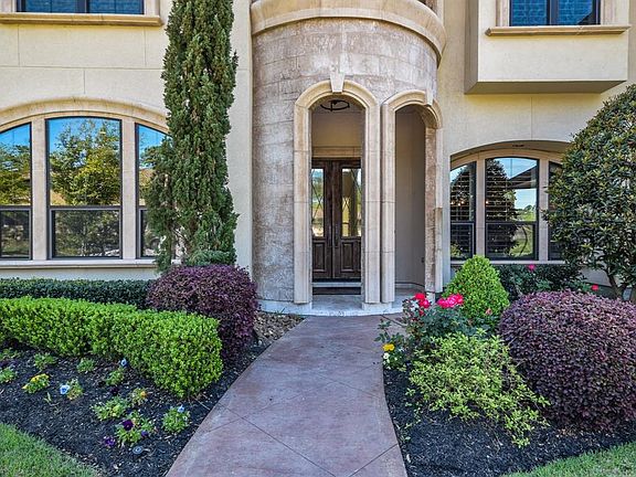 Incredible sophisticated entry with arched stone and stucco elevation to ensure the finest combination of design elements to give this home the rare distinction of elegance and comfort.