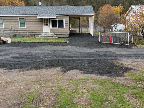 Front of duplex, with gate and fully fenced front yard.