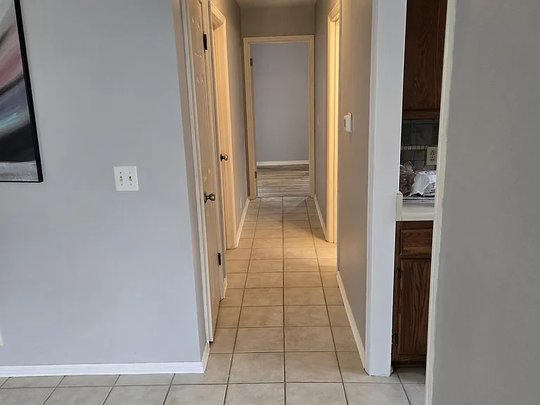 Looking from LR to down the hall to the pantry on the left (door closed) &
BR 2 on left (door closed) and MBR at the end. To the right is the upstairs bath