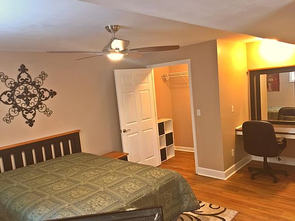 Queen sized bed with large walk-in closet and desk