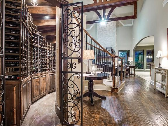 Custom wine bar under the stairs with built-in wine fridge.