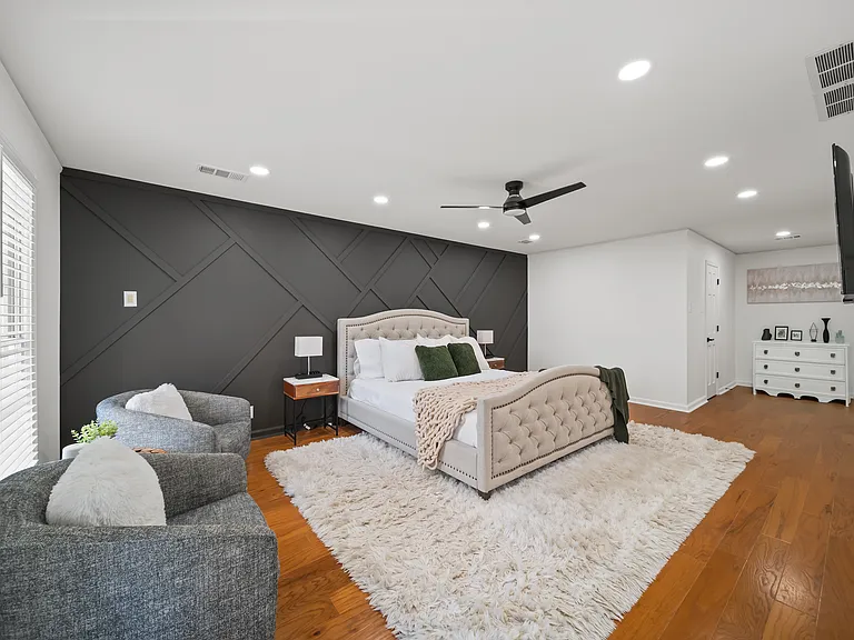 Relax and recharge in the luxury master bedroom featuring a king-size bed and Roku Smart TV, with a private ensuite bathroom designed for your comfort and convenience during this transitional time.