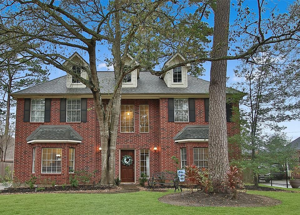 Mature, specimen trees frame the traditional front elevation and present a stately street presence.