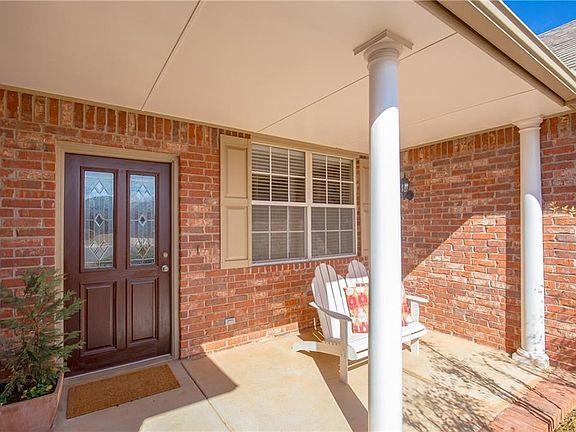 The Large covered porch is perfect for a morning cup of coffee and is made private by the many plantings that bloom in the spring and summer
