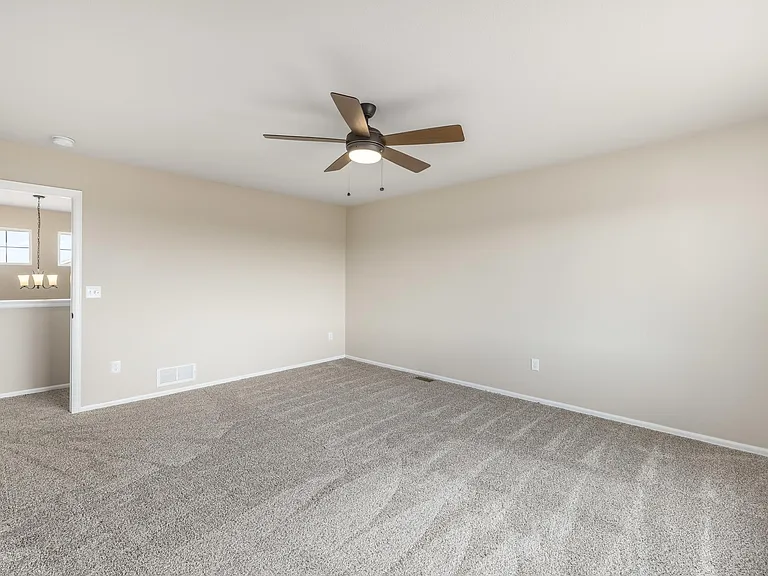 Large primary bedroom with fan, new carpet and attached 5 piece bathroom/walk-in closet