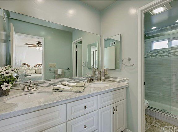Master bath with double sinks, granite counters and designer tiles.