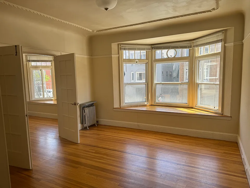 Bay windows and French doors separating main rooms