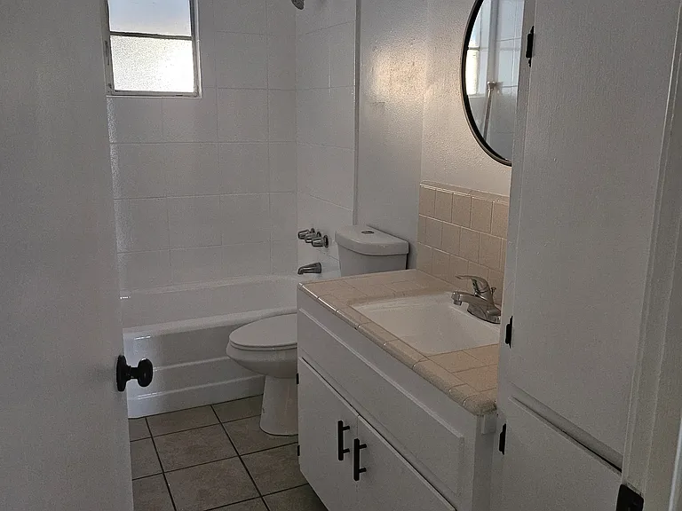 Bathroom with newly refinished tub and sink.
