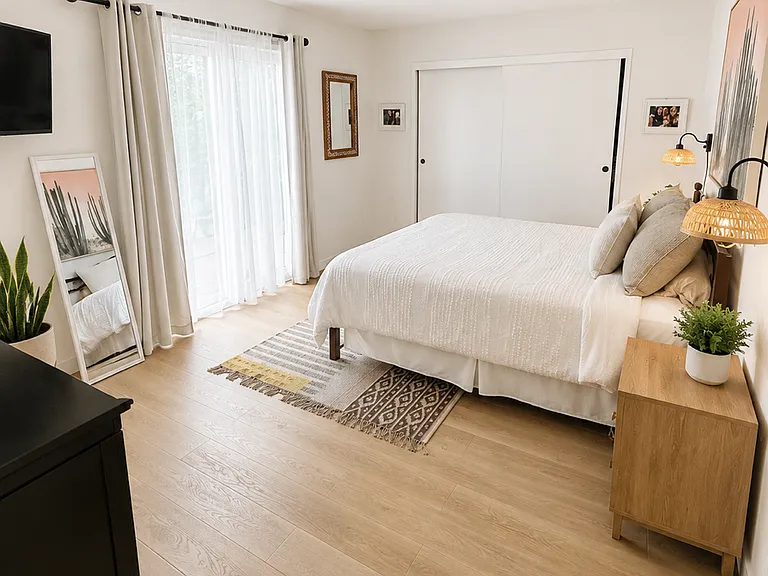 Downstairs bedroom with sliding door access to backyard and fruit trees along with access to the garage