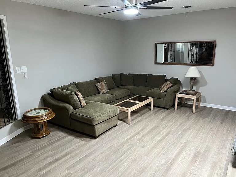 Living room 1 with a large sectional couch.