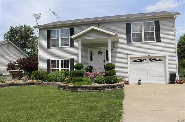This home is a WOW!  Look at the beautiful landscaping, full of perennials.