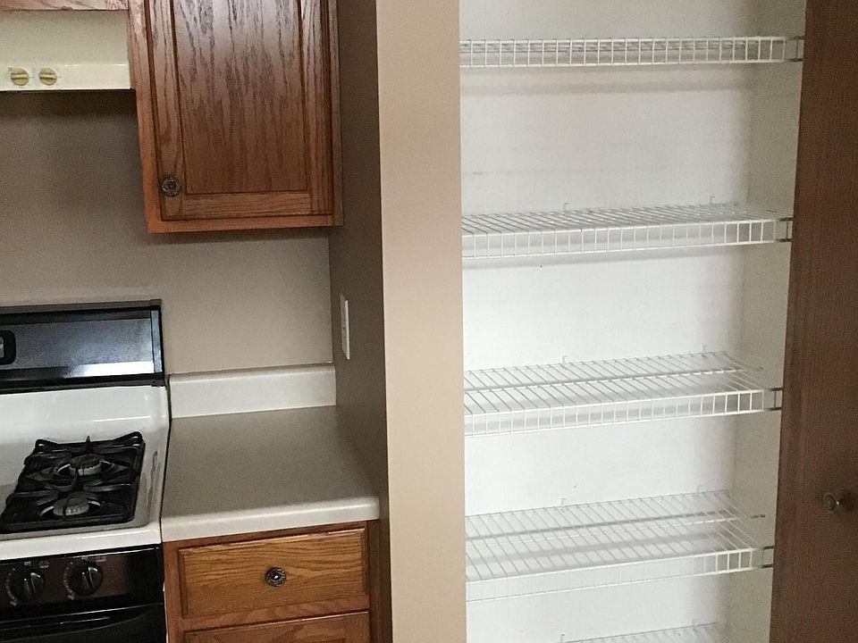 Kitchen features a 5 shelf pantry in addition to cabinets for ample storage space.