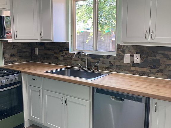 Kitchen with butcher block countertop and brand new appliances