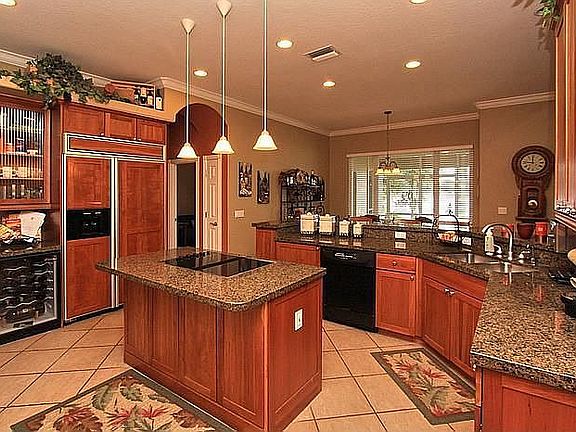 Delight in your Gourmet Kitchen w/ walls of cabinetry, granite & wine cooler