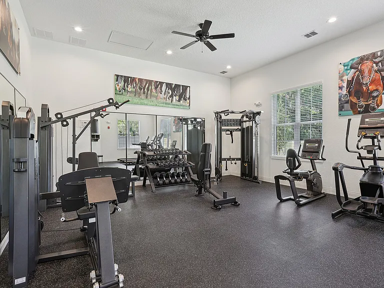 Modern fitness center with state-of-the-art equipment, including weight machines, cardio machines, and a bright, inviting atmosphere.