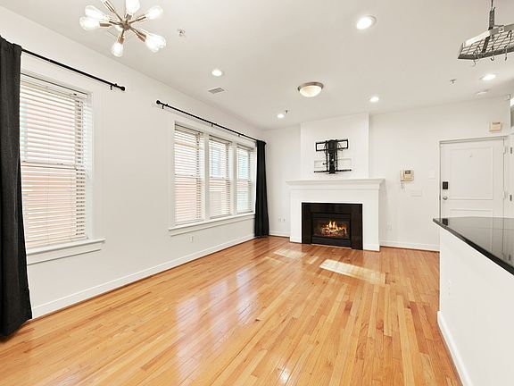 Sun-filled top-floor living with skylight, hardwoods, high ceilings, and gas fireplace