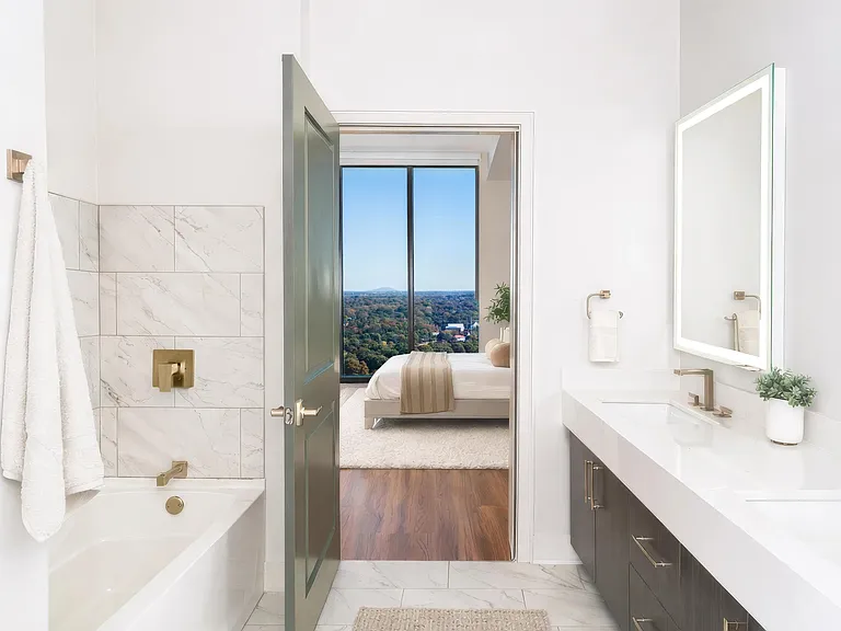 Penthouse bathrooms feature clean-lined finishes, generous vanities, and sightlines that open to sweeping views.