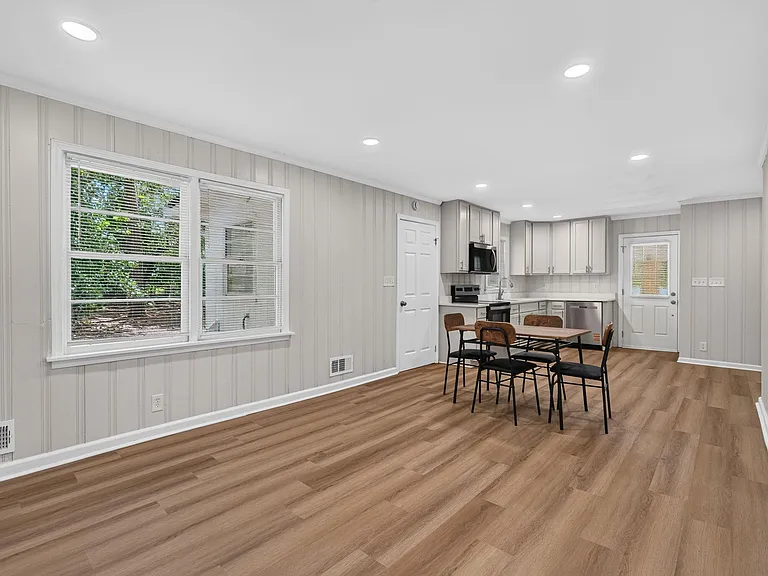Open-concept kitchen and dining area with ample cabinetry, full appliance set, and a spacious eat-in layout.