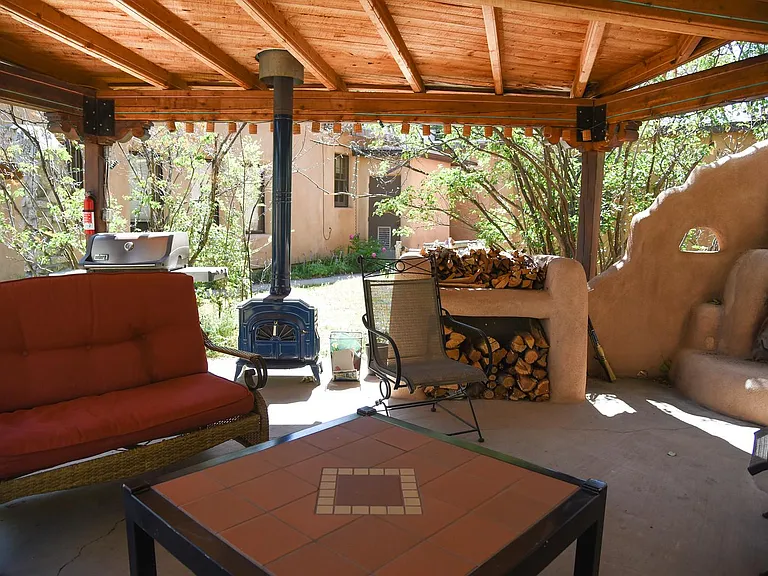 Covered patio with grill, stove and fireplace.