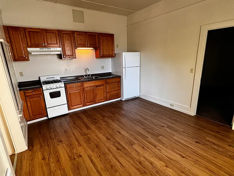 Kitchen (from dining area perspective). Vinyl plank flooring
