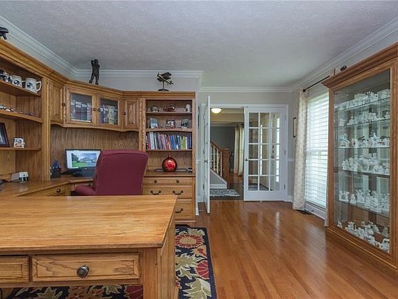 To your immediate left is the den featuring gleaming hardwood floors, crown molding and exquisite French doors (2017).