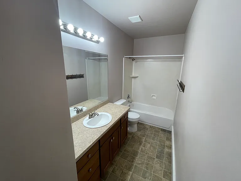 Extra bathroom off of kitchen as powder room/guest bath