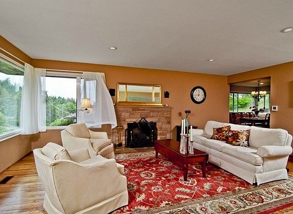 Light filled living room with gas fireplace.