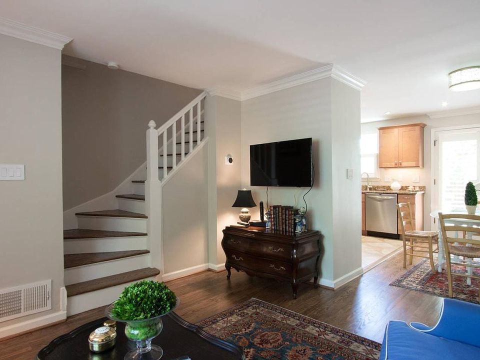 Living room with view to kitchen and dining area.