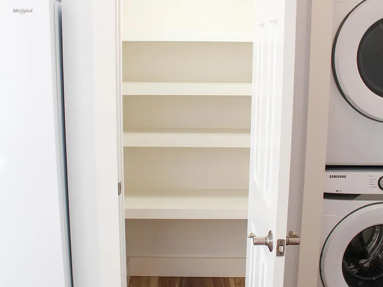 Walk-in pantry with outlet and light with lots of shelving and storage for your kitchen countertop appliances.