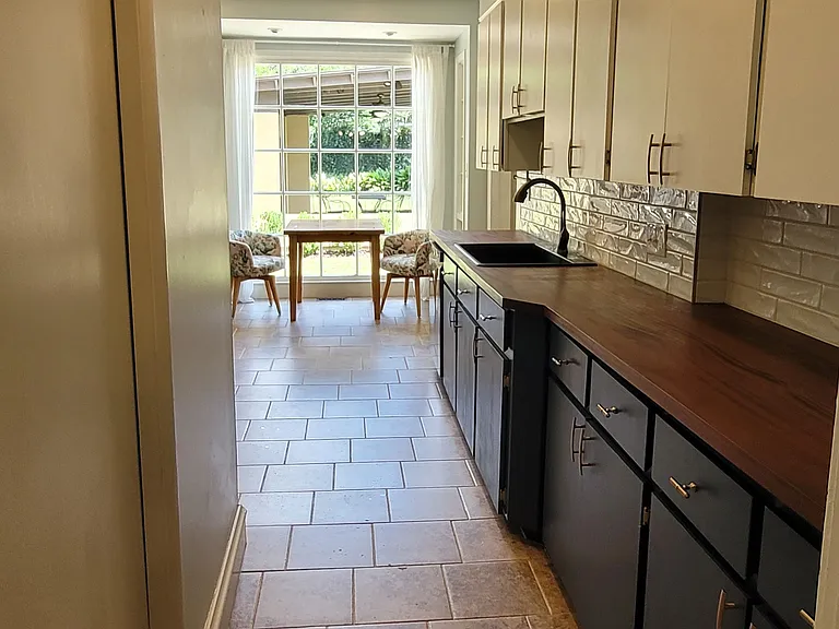 Entrance to kitchen from dining room. Laundry room behind pocket door to the left.