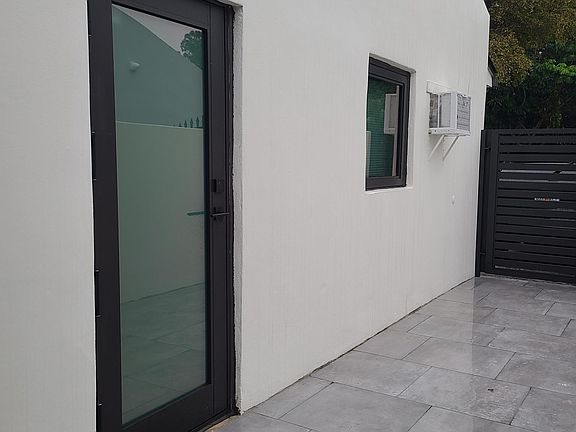 Private entrance with a new impacted door and windown.
