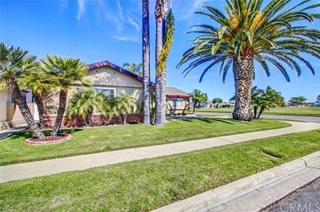 Front view of home with partial view of 8+ acre park