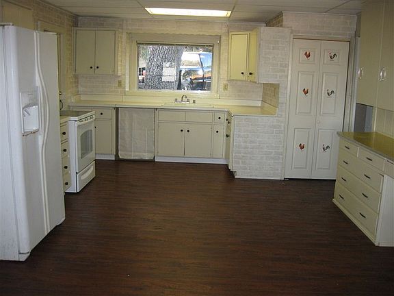 Wood floors in big kitchen/dining room. Built-in desk, lots