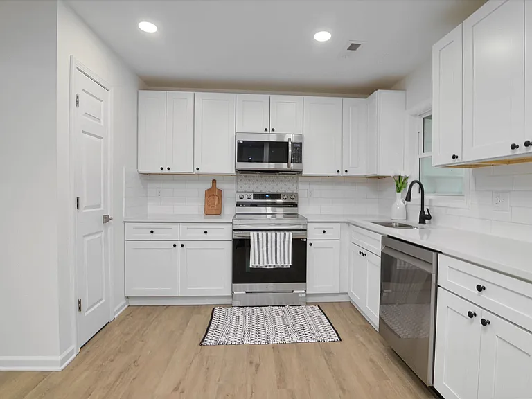 well-equipped kitchen with a refrigerator, microwave, dishwasher, and electric range, making meal prep a breeze