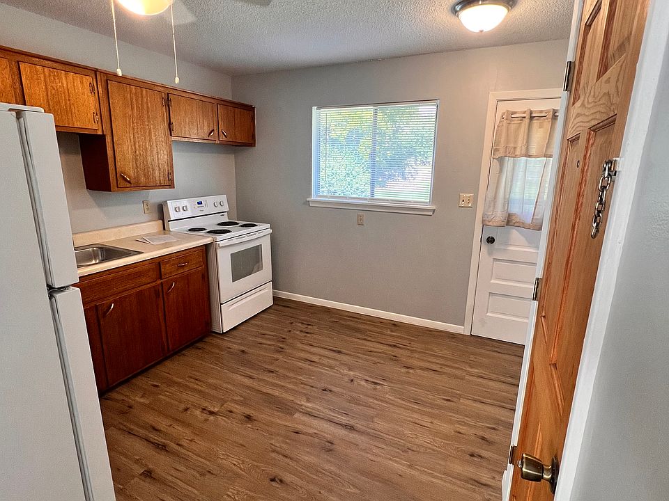 Kitchen from living room. See entry door on right, white door is to shared deck.