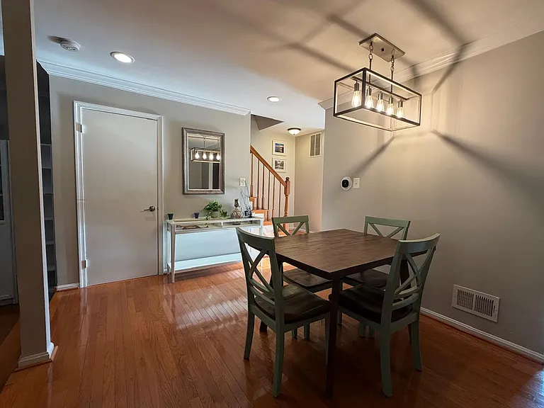 Same living room area, now with new paint, crown molding, and some furniture