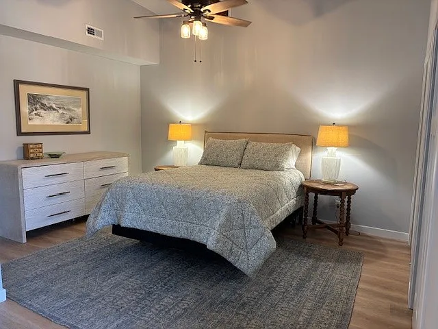 Bedroom 1 is large with LVP floors and ceiling fan.