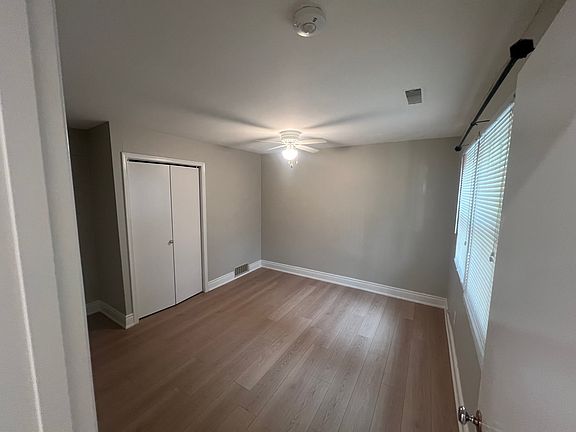 Front bedroom with large window and closet.