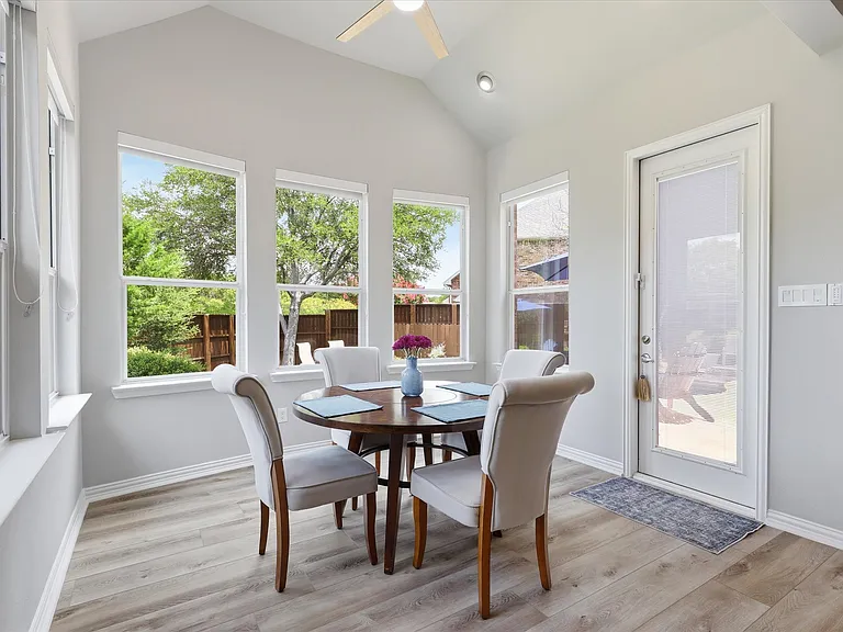 Sunny breakfast room with views of the pool and family room.