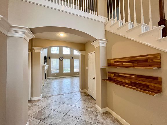 Two story foyer viewing into living room