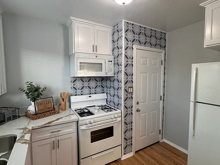 Kitchen with rear entry door.