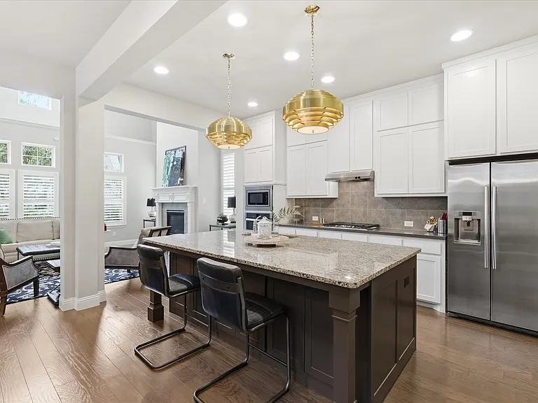 A gourmet chef's kitchen featuring an expansive central island optimized for daily meal prep or effortless entertaining