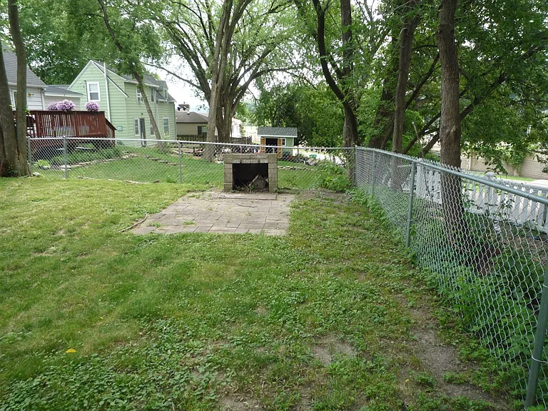 Chain Link Fencing around back yard, fire place for outdoor cookouts