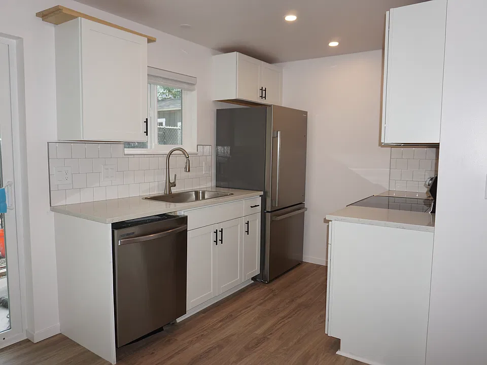 Kitchen - stainless steel refrigerator, stove/oven, dishwasher, and one large sink