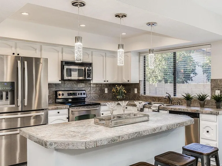 This kitchen is fully equipped from coffee maker to pots and pans, containers, plates, bowls, glassware, silverware, and so much more
