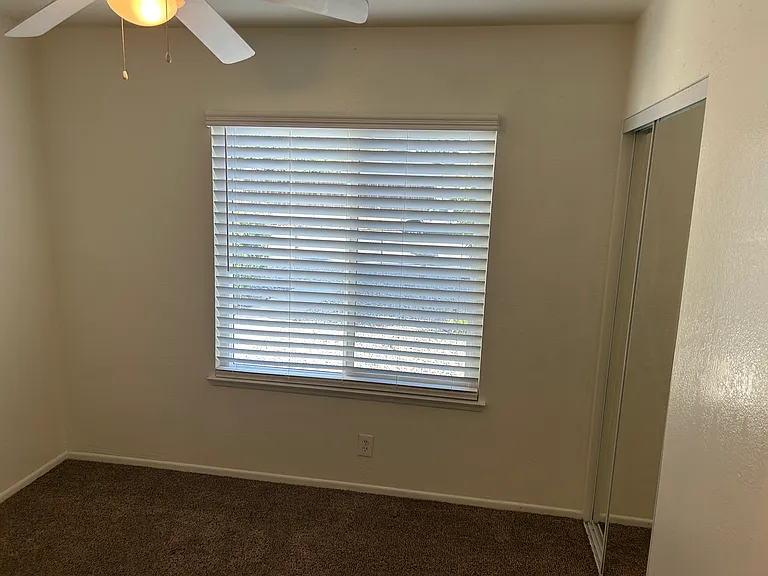 SE BEDROOM WITH 2" CUSTOM BLINDS AND MIRRORED DOORS